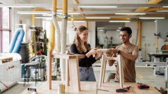 Architecture student examining a building model