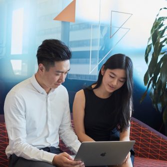 Post graduate students working on computers, talking and studying at the business school, Kensington UNSW