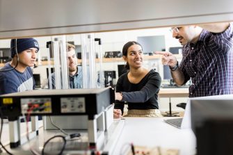 Engineering students in classroom with equipment