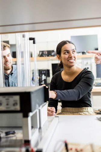 Engineering students in classroom with equipment