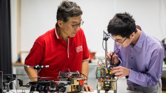 Engineering student and teacher in workshop