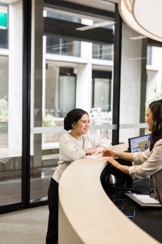 Female student asking questions at Student Services