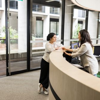 Female student asking questions at Student Services desk