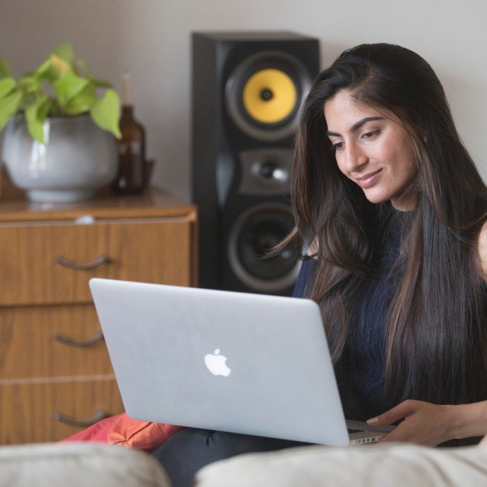 Student studying on couch with laptop