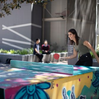 Students playing table tennis near Figtree theatre