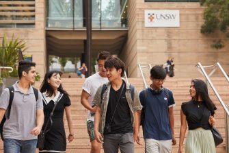 Students on walking down steps on campus