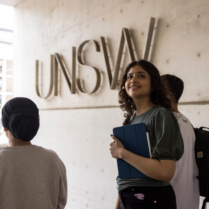 Female student standing in front of UNSW logo on L5 steps Female student standing in front of UNSW logo on L5 steps