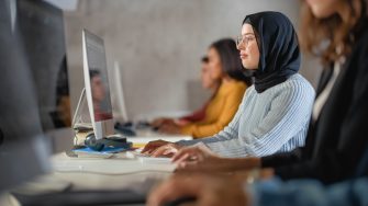 Three students with their laptops