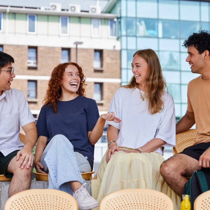 Group of students UNSW College students sitting outside, talking