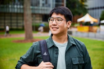 Beautiful UNSW College Student standing outside on the main walkway, solo student