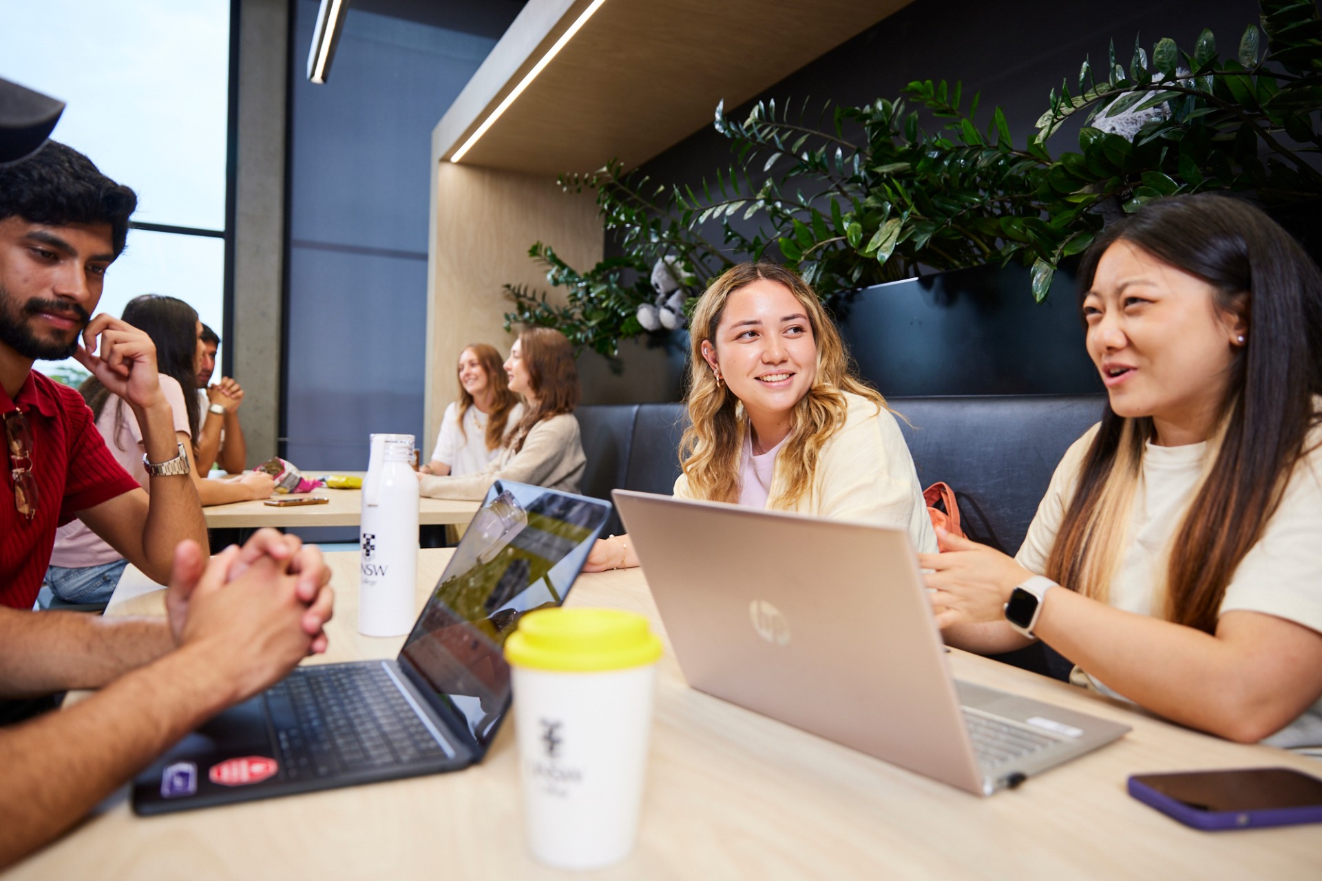 UNSW College Students seated together, laptops open, chatting in common room
