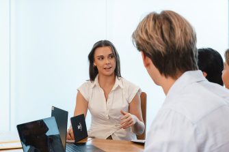 A woman discusses her idea with a man