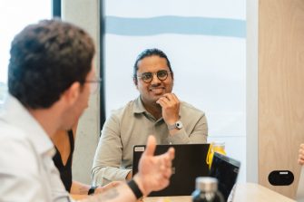 Two men talking at a desk
