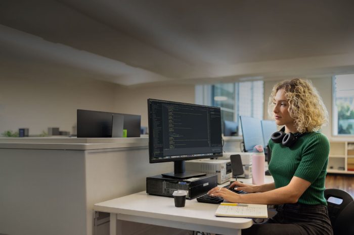 Female Applied Degree student with blonde curly hair working on desktop computer