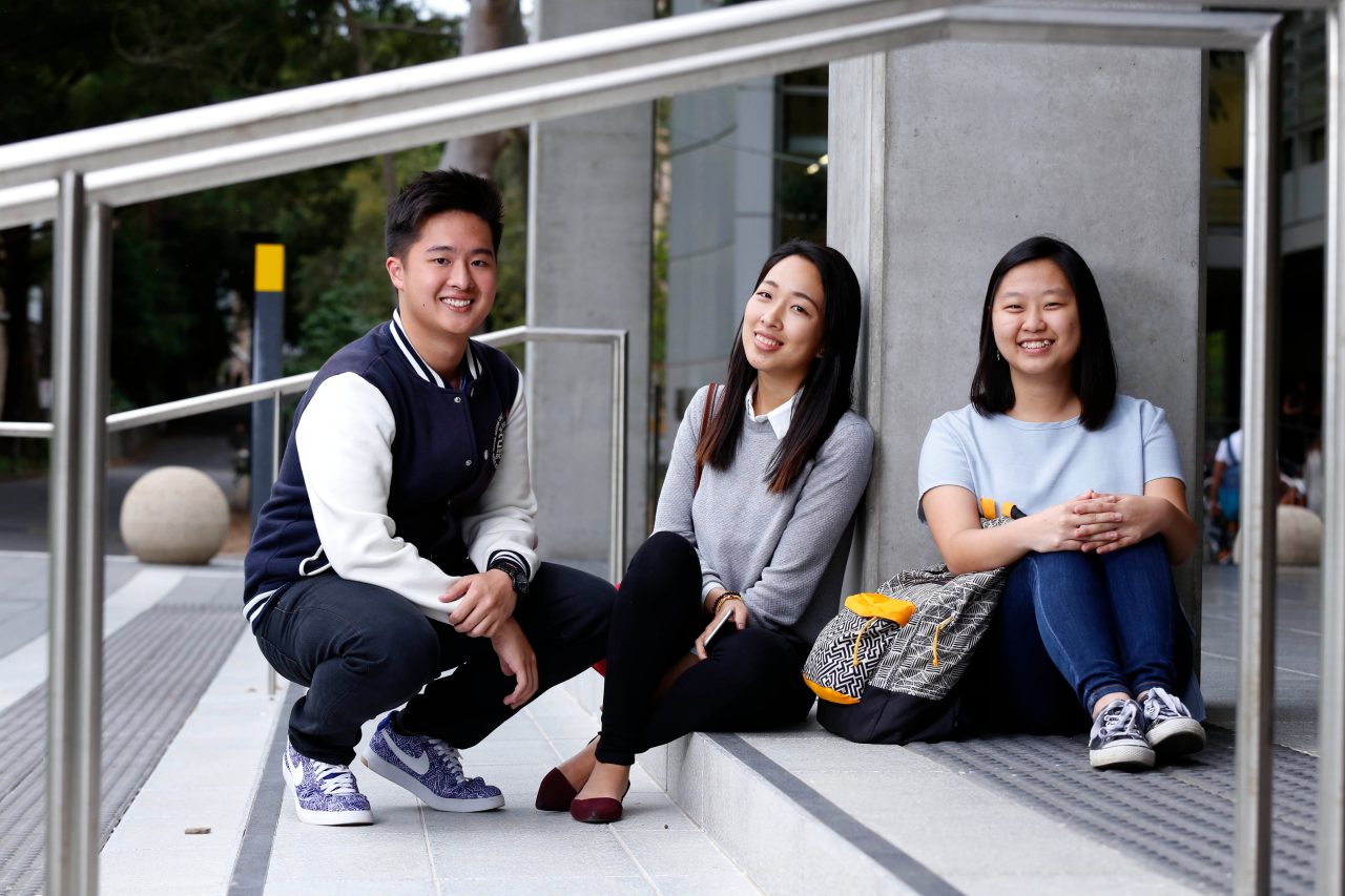 Students sitting on stairs on campus