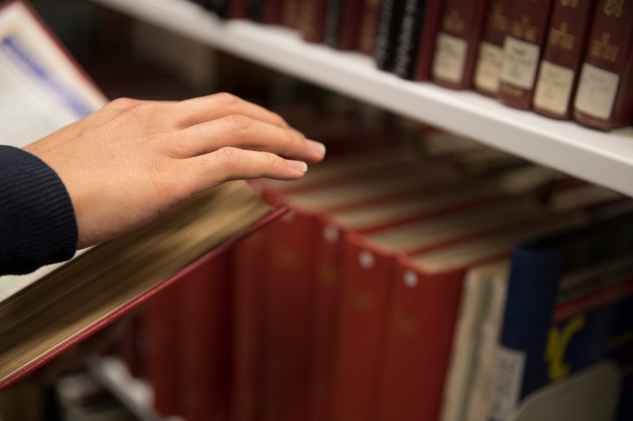 Hand on books in library