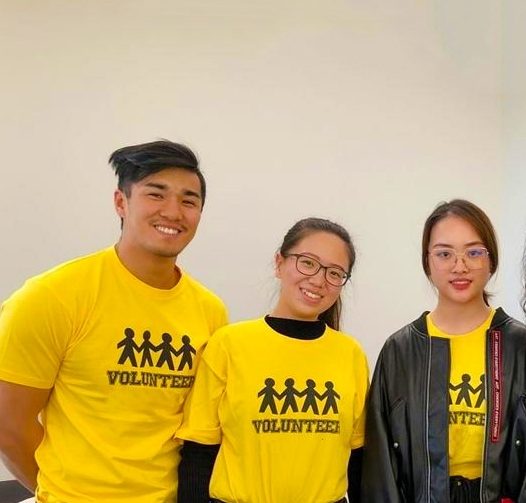Student volunteers in yellow shirts