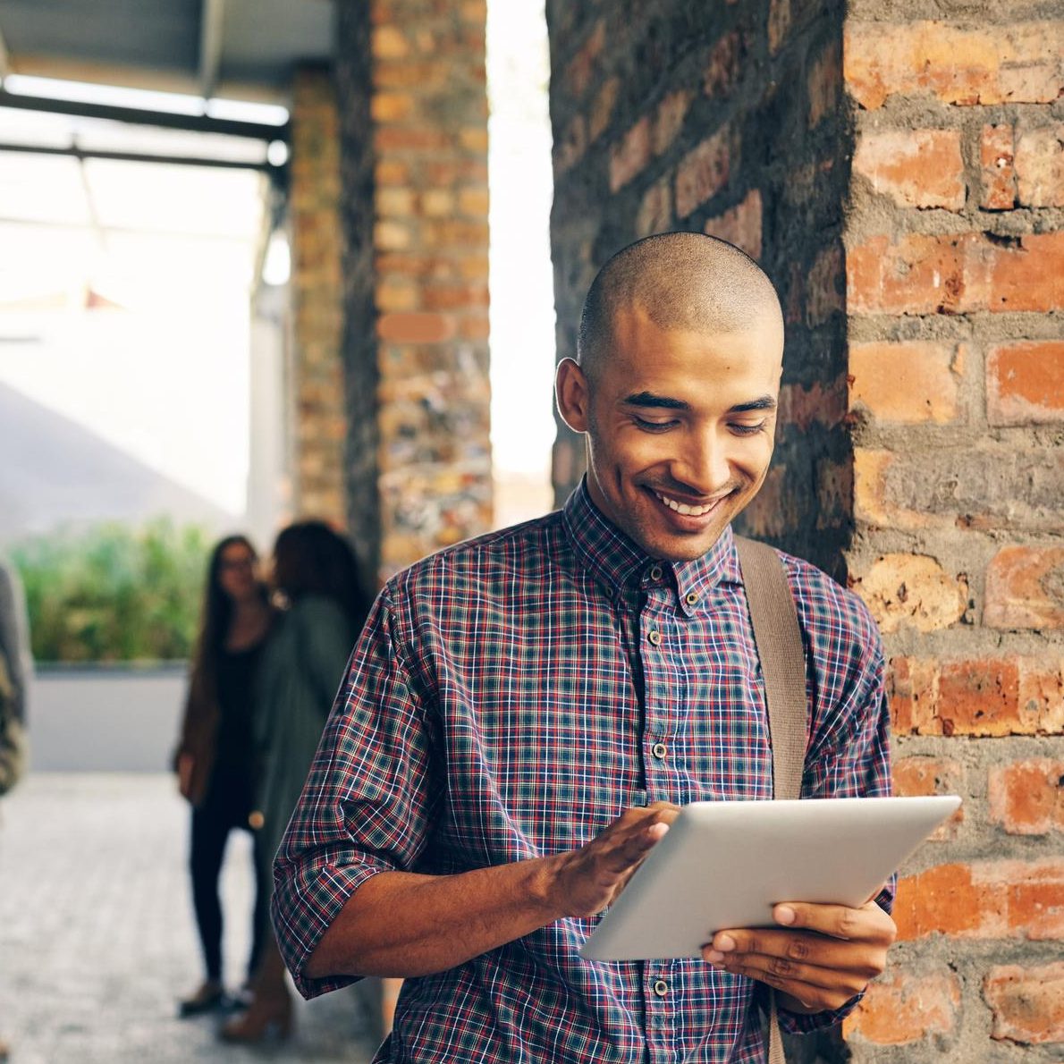 Student on campus looking at a tablet