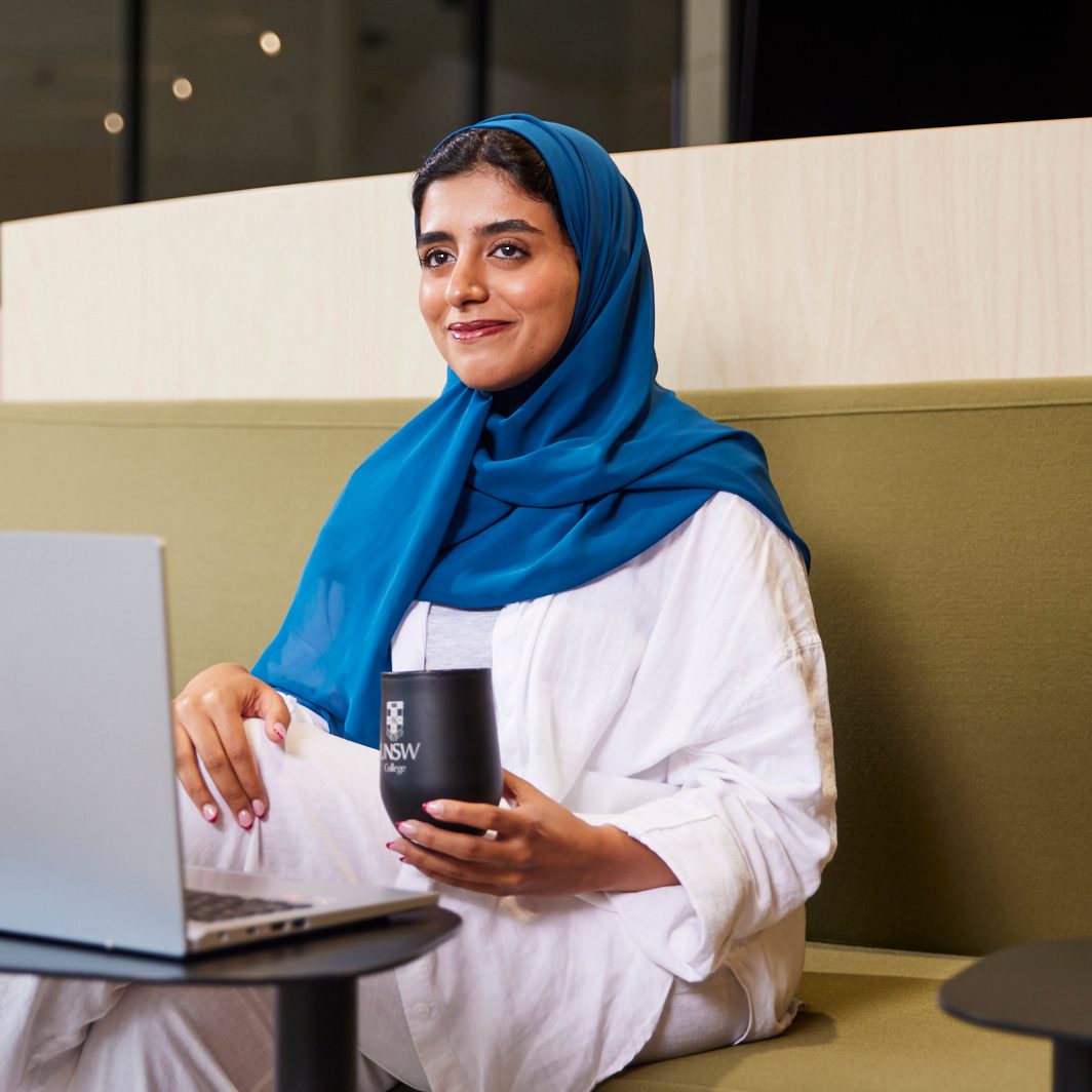 UNSW College Student at Student Hub, wearing scarf, laptop, coffee cup