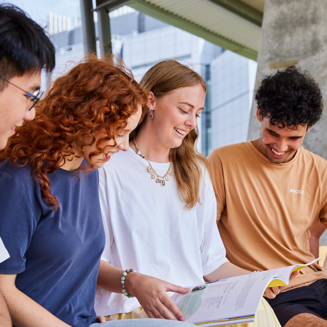 UNSW College students sitting outside, talking
