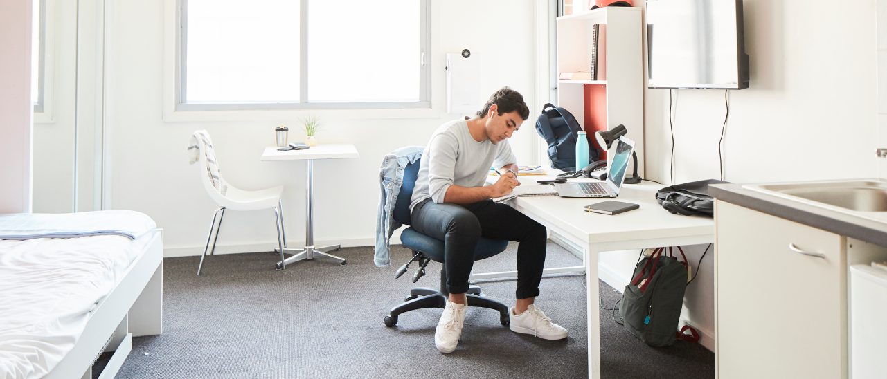 Student studying at the desk in their student accommodation