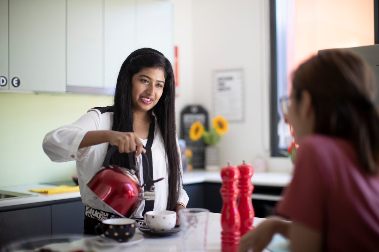 Students having tea in kitchen of student accommodation