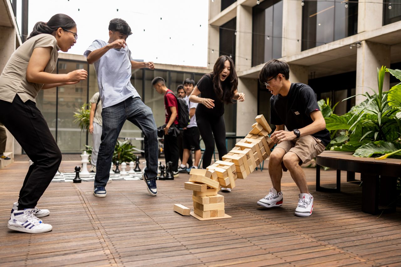 UNSW College - Students playing Jenga in the courtyard at L5