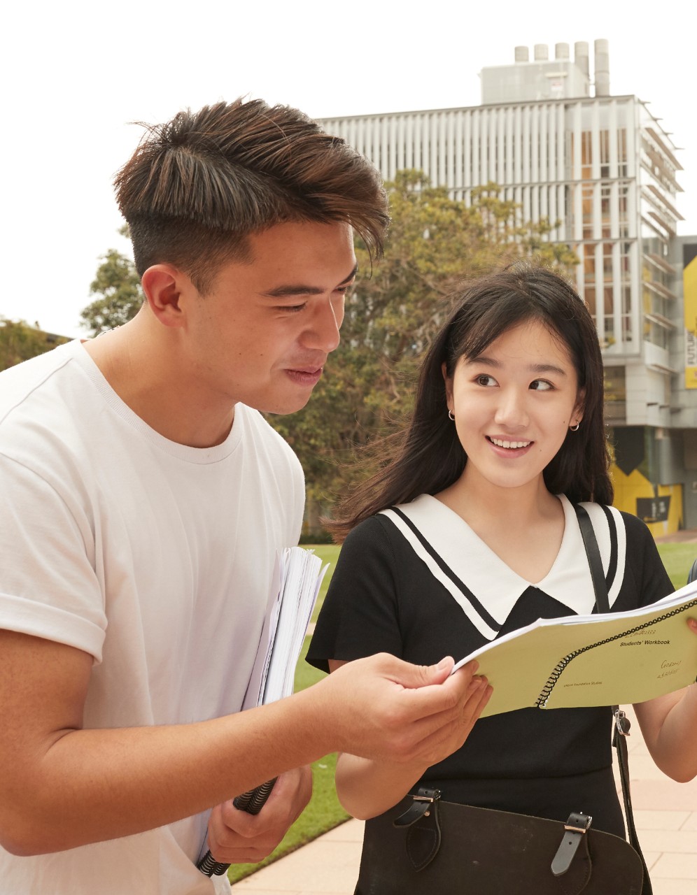 Global student's helping each other on main walkway