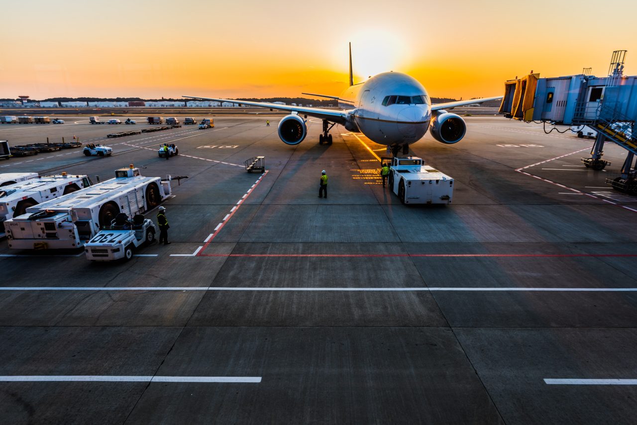 Plane sitting on the tarmac at sunrise or sunset