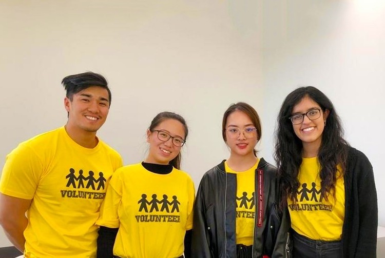 Student volunteers in yellow shirts