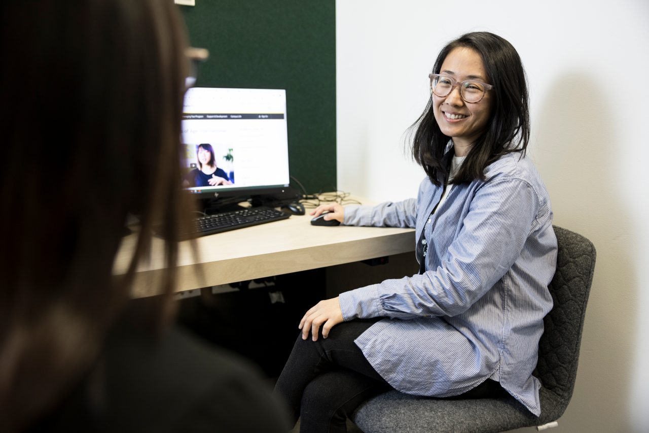 Student Advisor helping student at desk