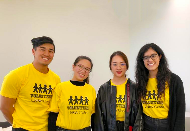 Student volunteers in yellow shirts