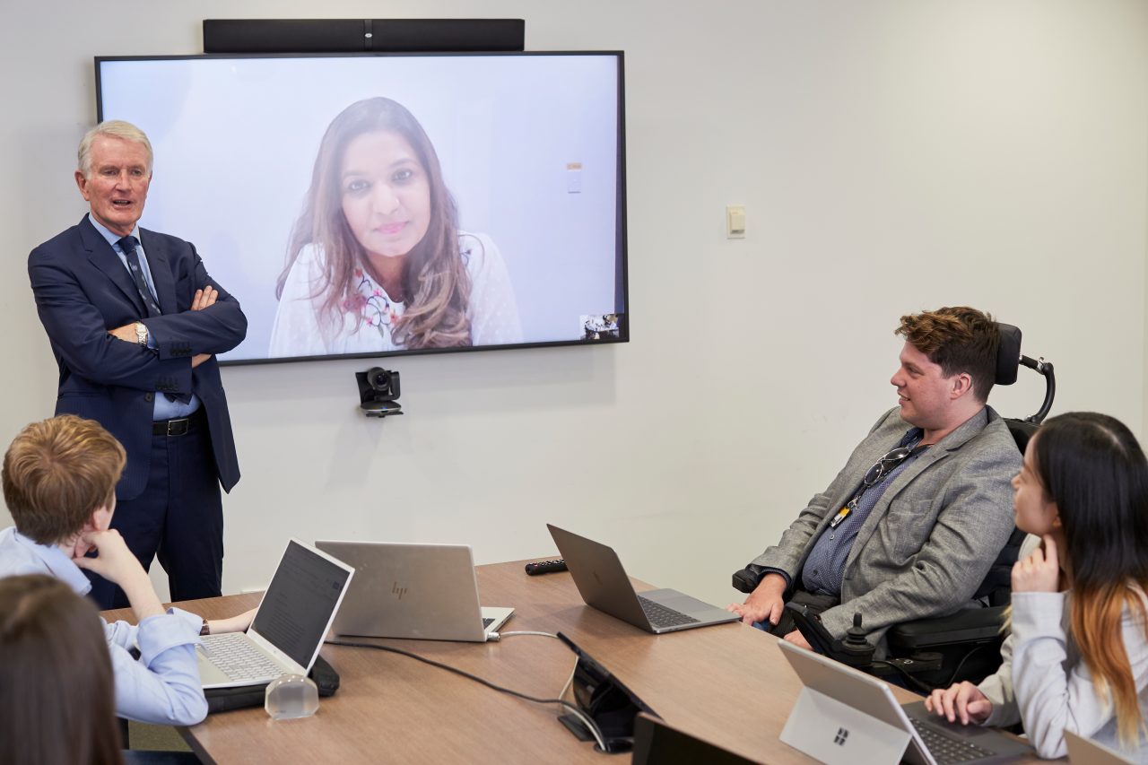 Students in Law PhD Room talking to other students with remote access via internet.