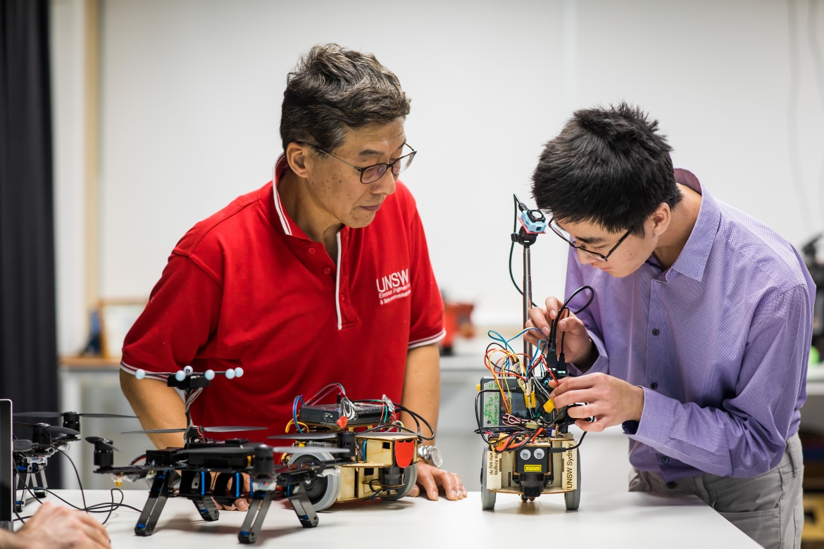 Engineering student and teacher in workshop