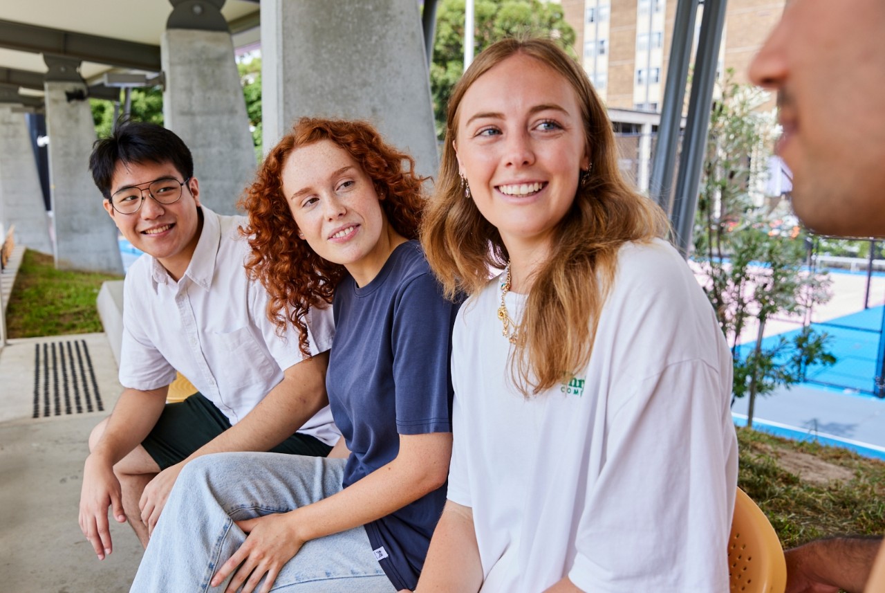 UNSW College students sitting outside, talking