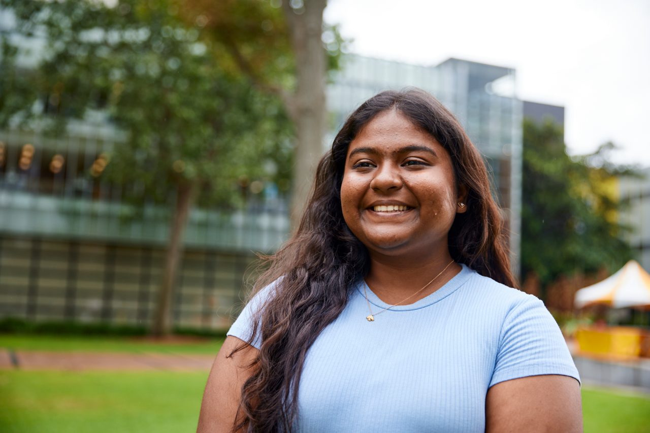 Beautiful UNSW College Student standing outside on the main walkway, solo student