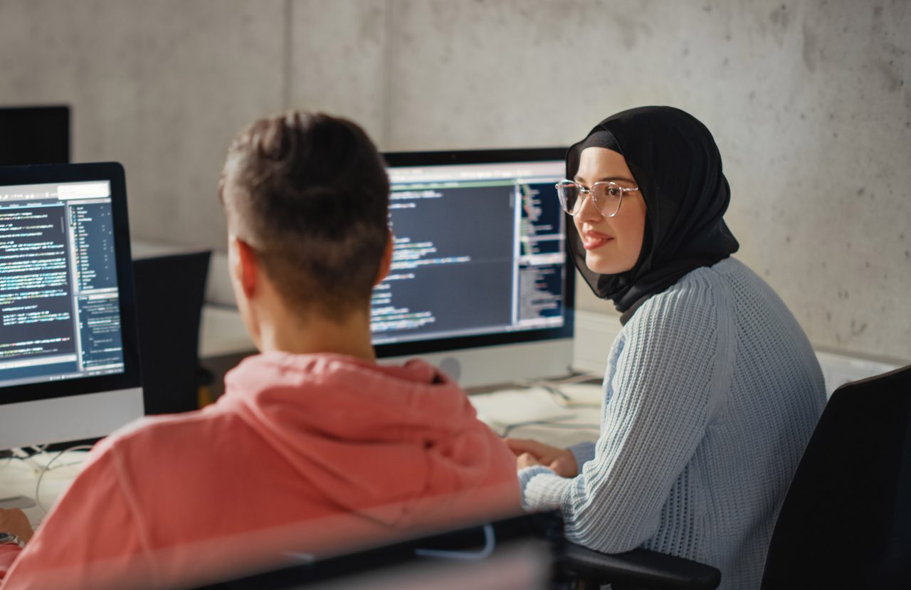 Smart Young Students Studying in University with Diverse Multiethnic Classmates. Scholars Collaborate in College Room on Computer Science Project, Writing Software Code in Successful Teamwork.